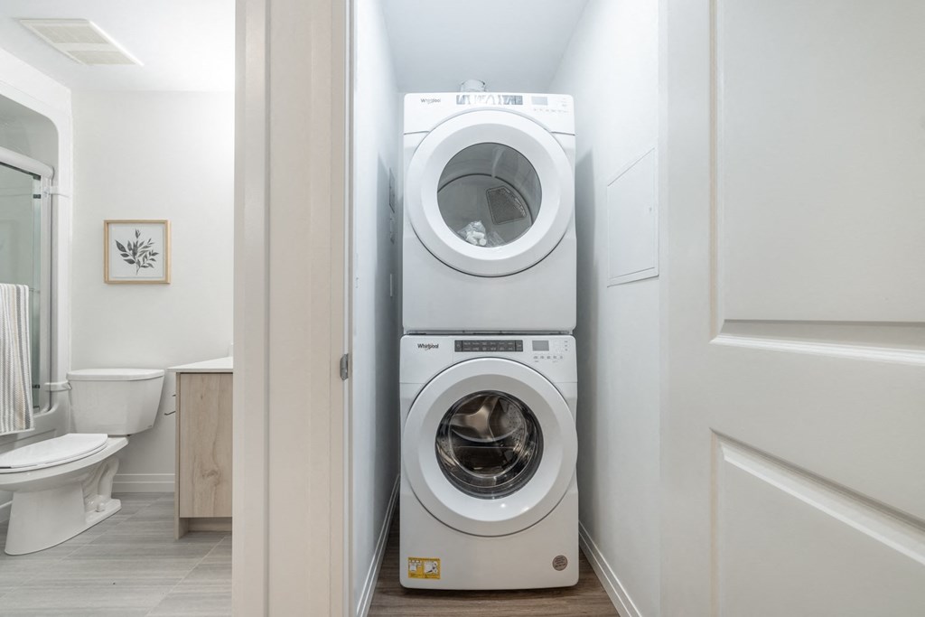 a white washer and dryer in a small laundry room