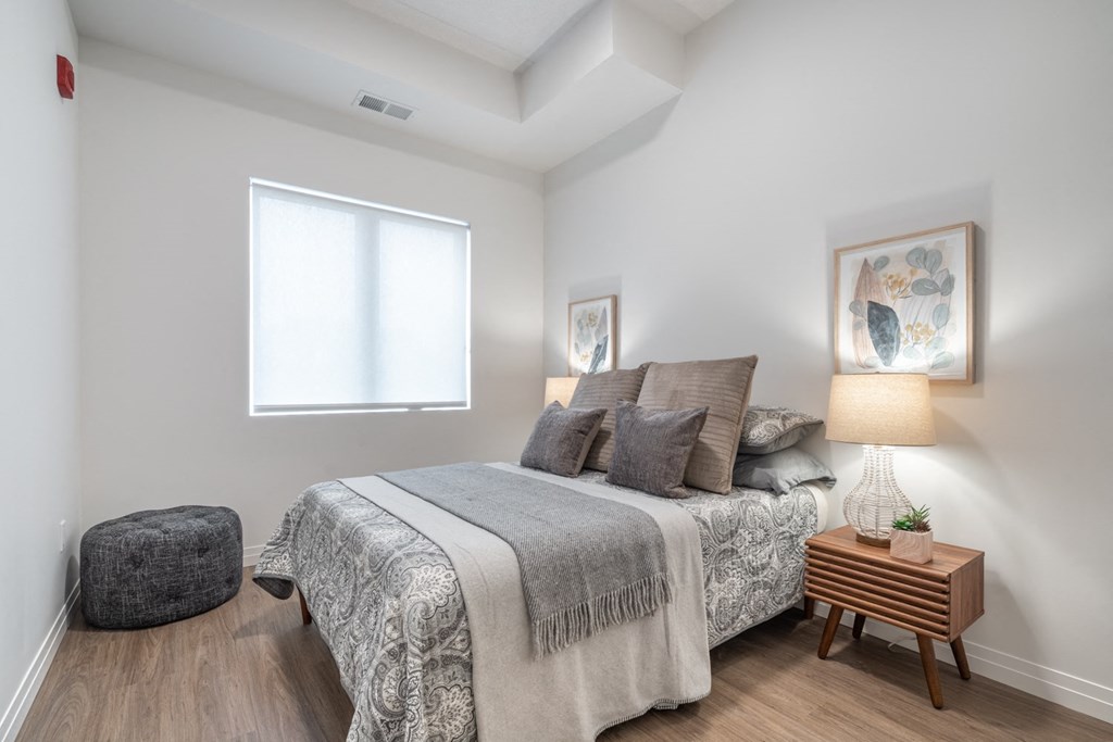 a bedroom with a bed and a window