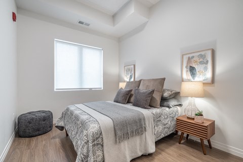 a bedroom with a bed and a window