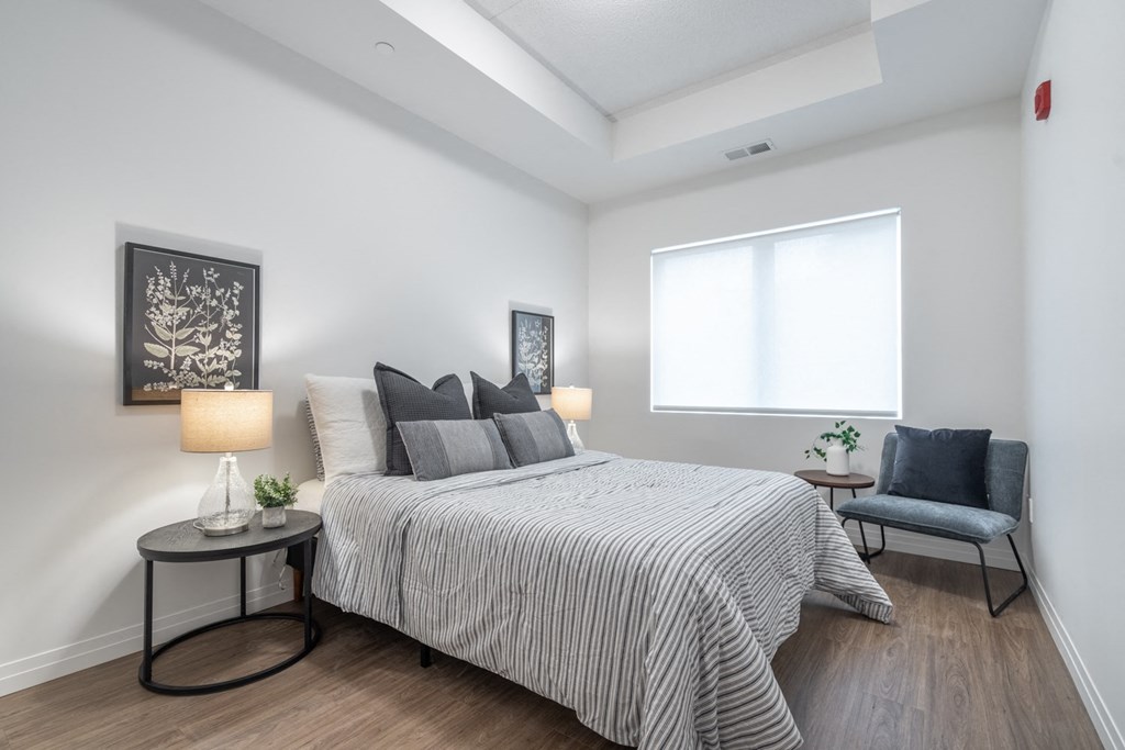 a bedroom with a large bed and a window