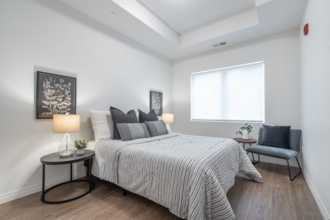 a bedroom with a large bed and a window