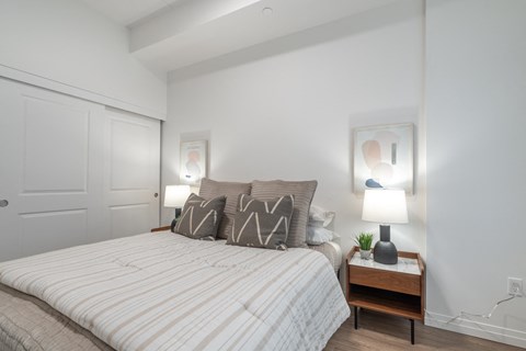 a bedroom with a large bed and white walls