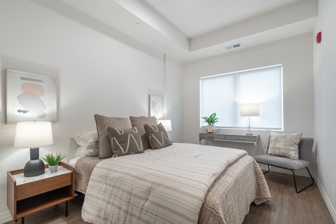 a bedroom with a large bed and a window