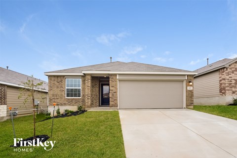 A house with a garage door is for sale by FirstKey Homes.