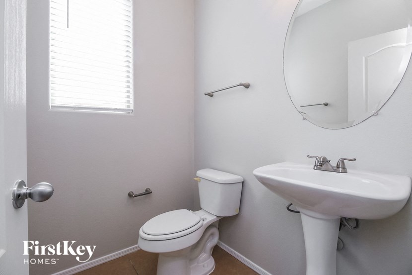a bathroom with a sink toilet and a mirror