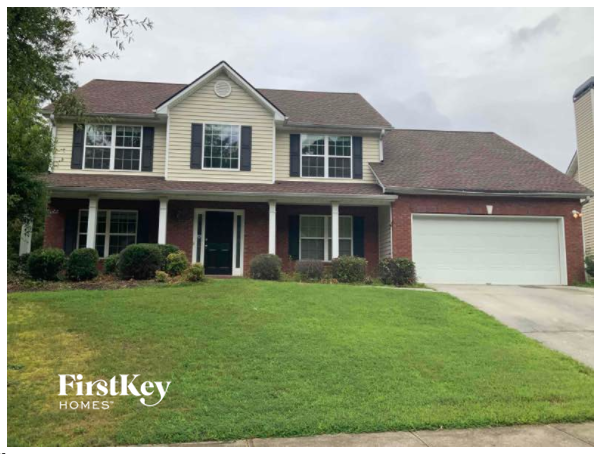 a house with a lawn and a white garage door