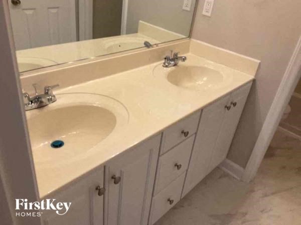 a bathroom with two sinks and a mirror