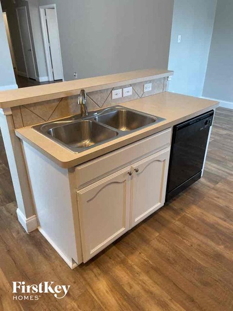 a kitchen with a stainless steel sink and a counter top