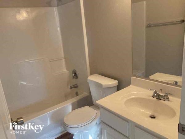 a bathroom with a sink toilet and a bath tub