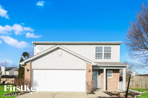 A house with a garage and a driveway is for sale.