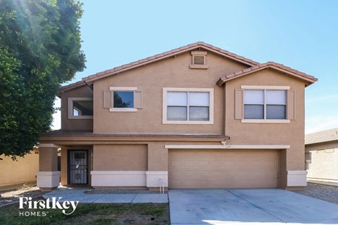 A two-story house with a garage is for sale.