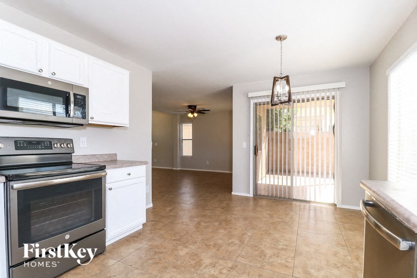 A kitchen with a stove top oven and microwave.