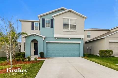 a blue and white house with a blue garage door