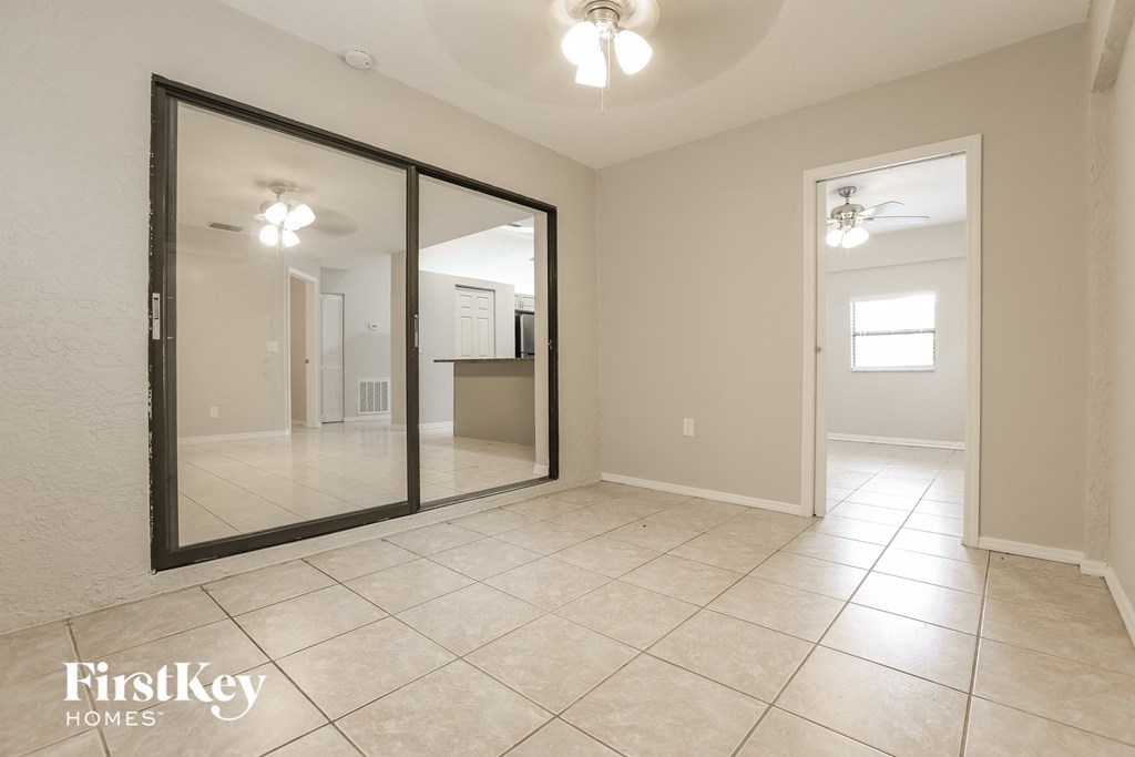 a large mirror in the center of a room with a tiled floor