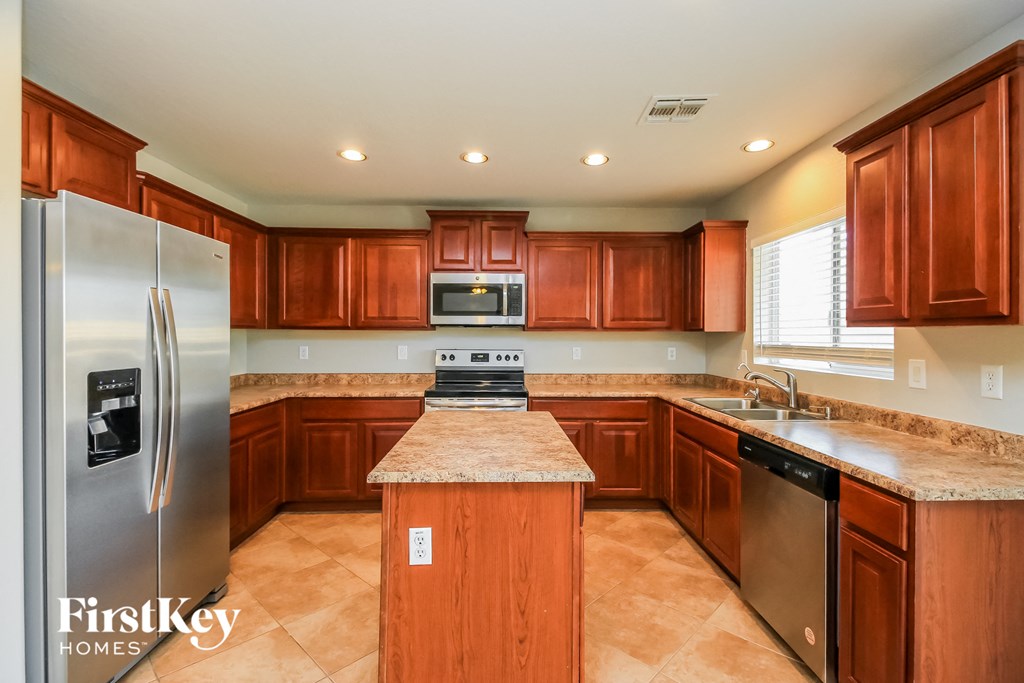 full view of kitchen with stainless steel appliances and granite counter tops