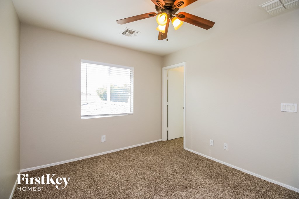 the master bedroom has a ceiling fan and carpeted flooring
