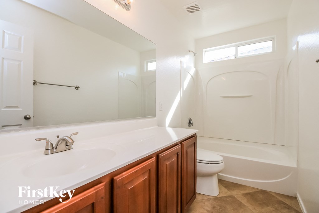 a bathroom with a sink and a toilet and a shower