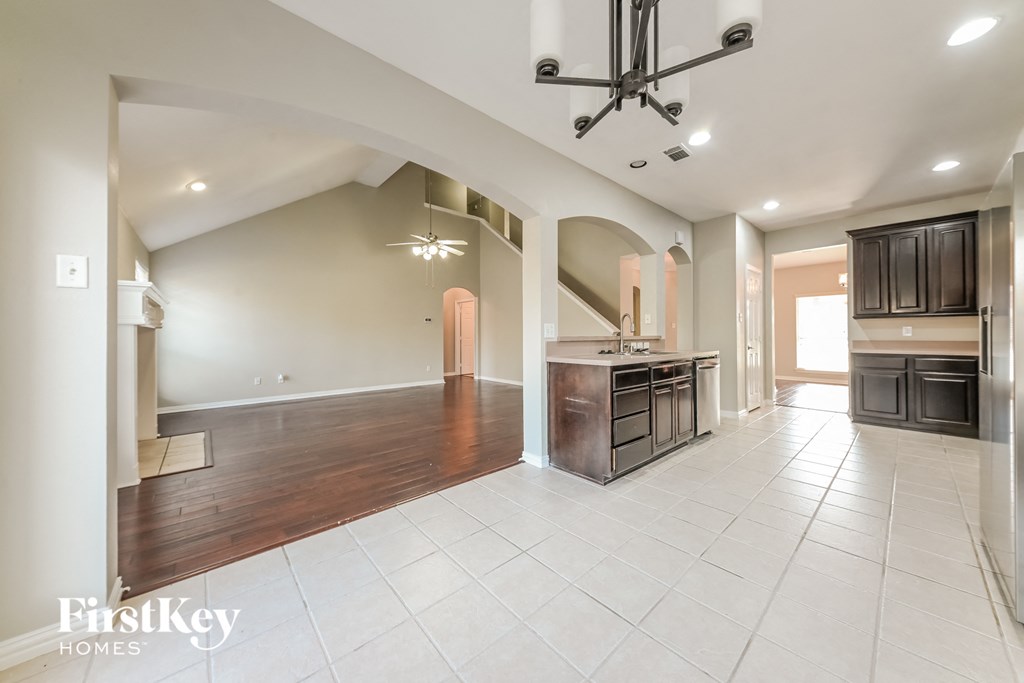 A spacious kitchen with a dining area and a living room.