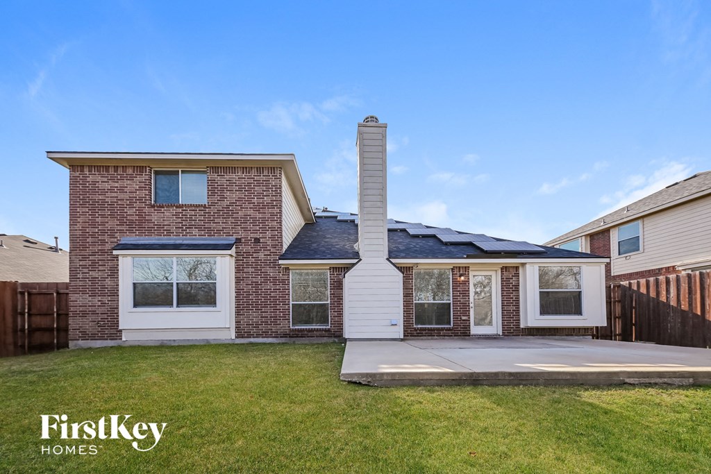 A brick house with a chimney and a garage door.