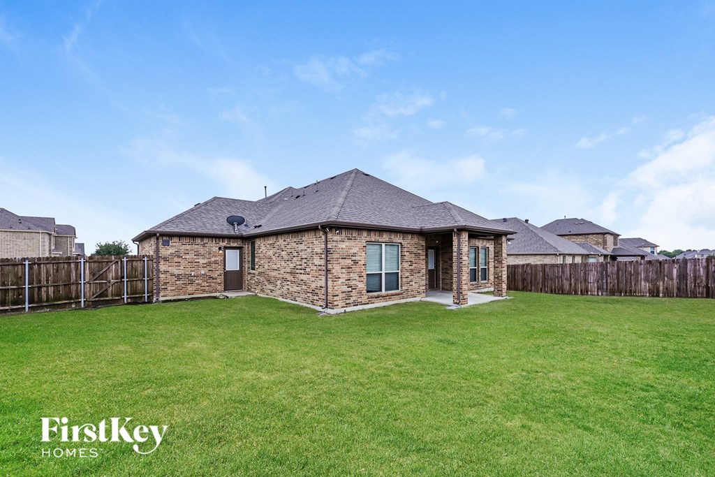 A house with a lawn in front of it.