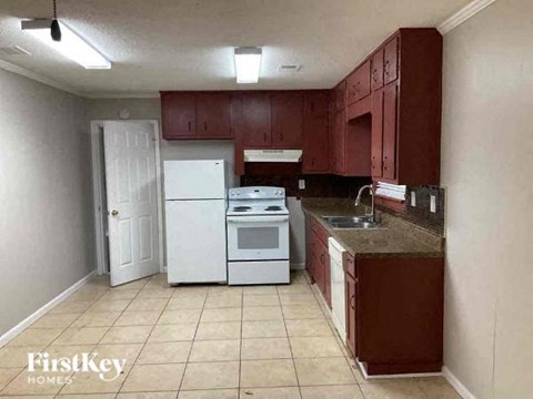 a kitchen with a stove refrigerator and sink
