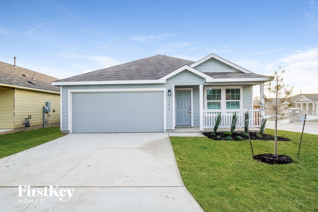a blue house with a sidewalk in front of it