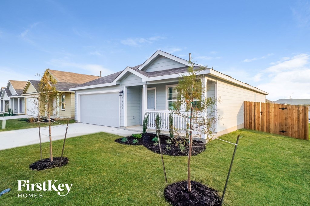 a home with three trees in the front yard