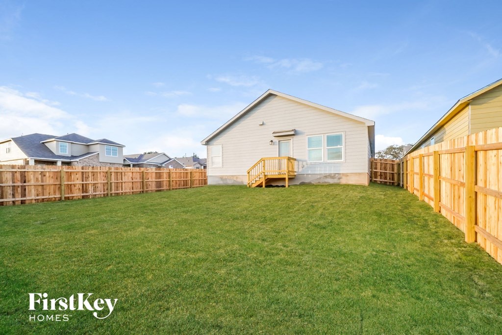 a fisheye view of a backyard with a fence and a house