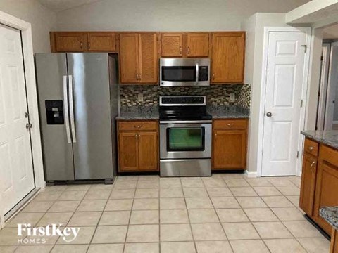 a kitchen with stainless steel appliances and wooden cabinets