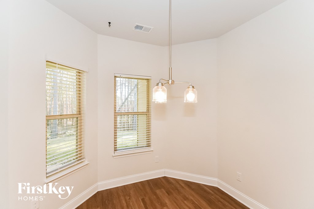 A room with a window and a light hanging from the ceiling.