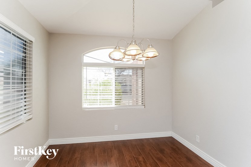 a dining room with a window and a chandelier