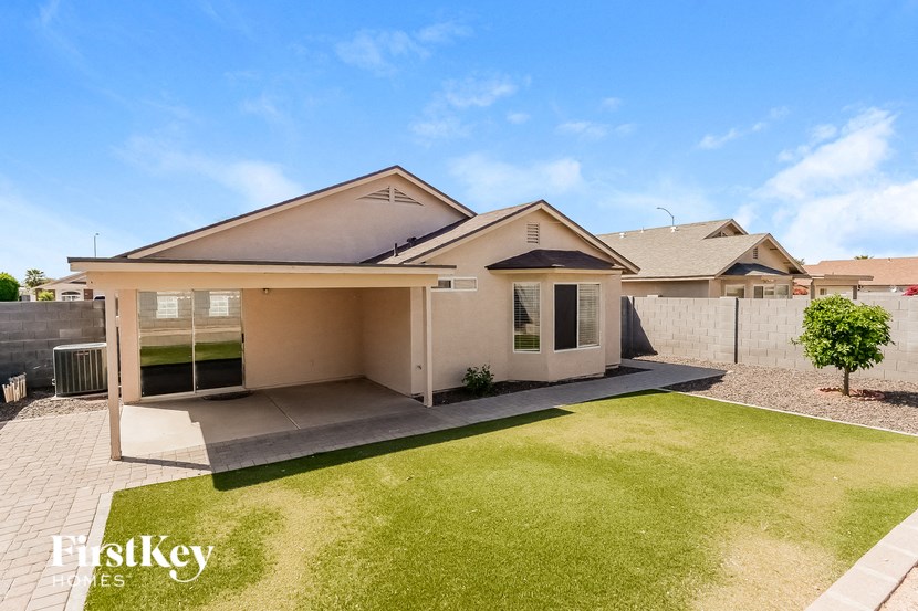 a house with a lawn and a fence