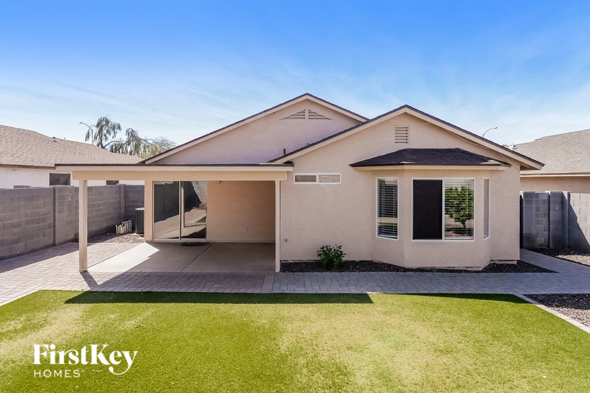 a white house with a lawn and a patio