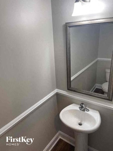 a small bathroom with a white sink and a mirror