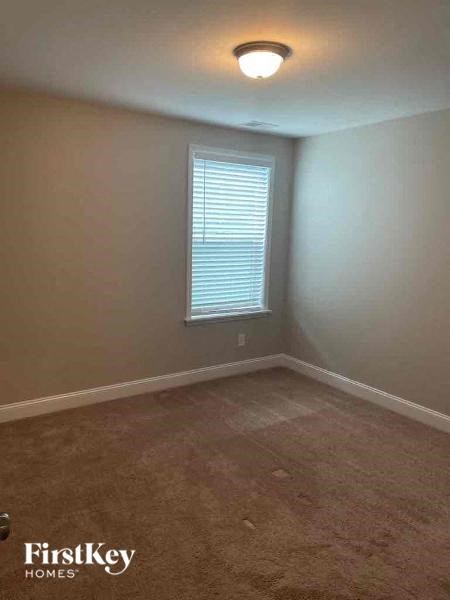 a empty room with a window and a light on the ceiling