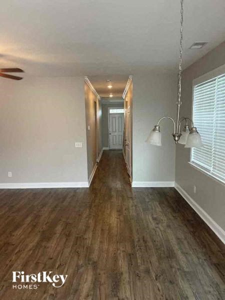 a empty living room with a hard wood floor