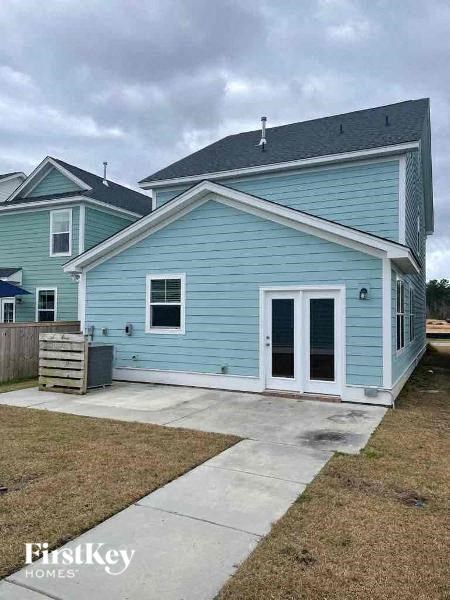 a blue house with a sidewalk in front of it