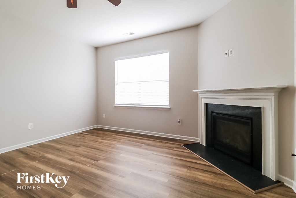 A room with a fireplace and a window.
