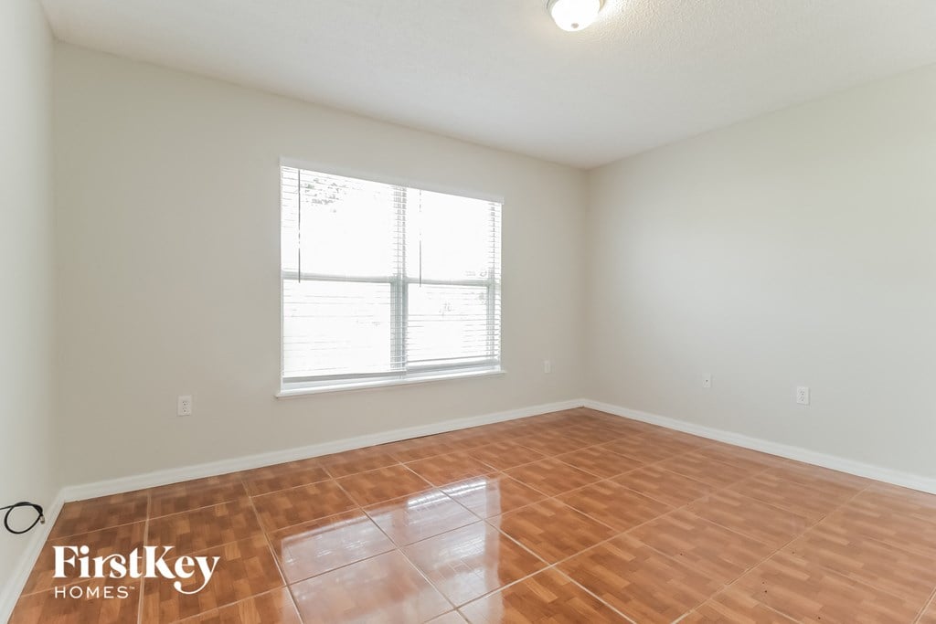 a living room with wood floors and a window