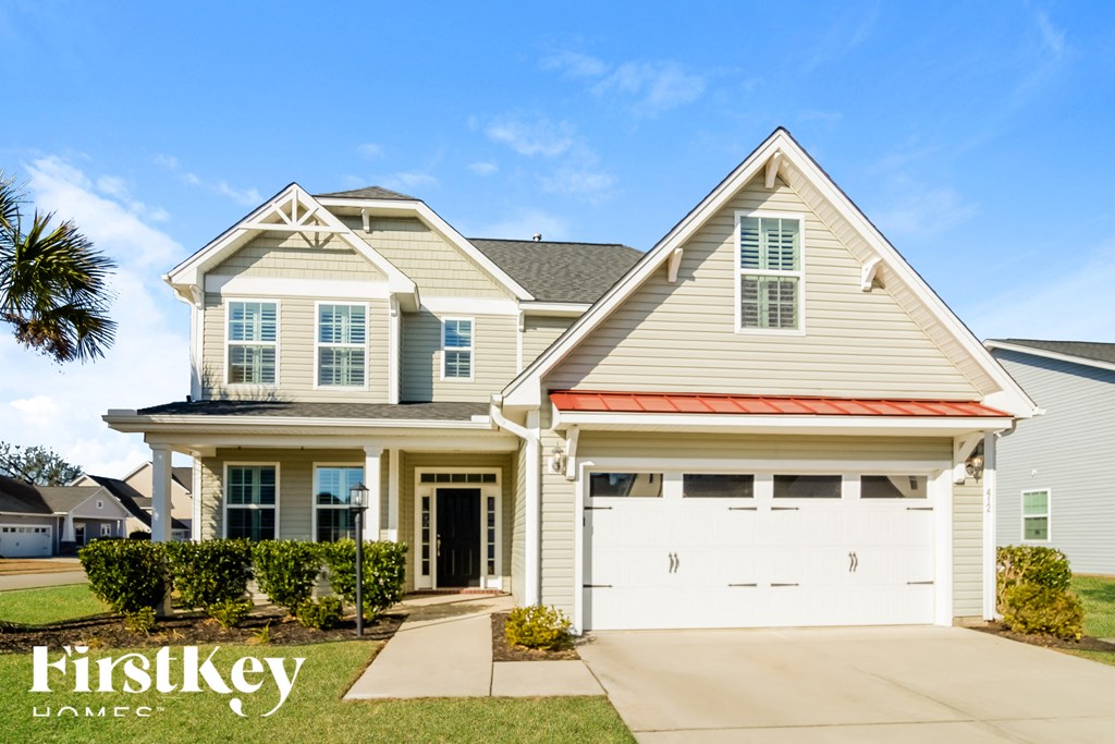 A two-story house with a garage is showcased in the image.