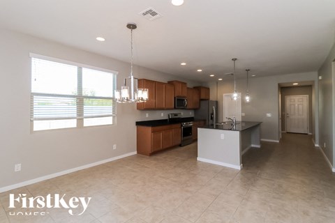 A spacious kitchen with wooden cabinets and a black countertop.