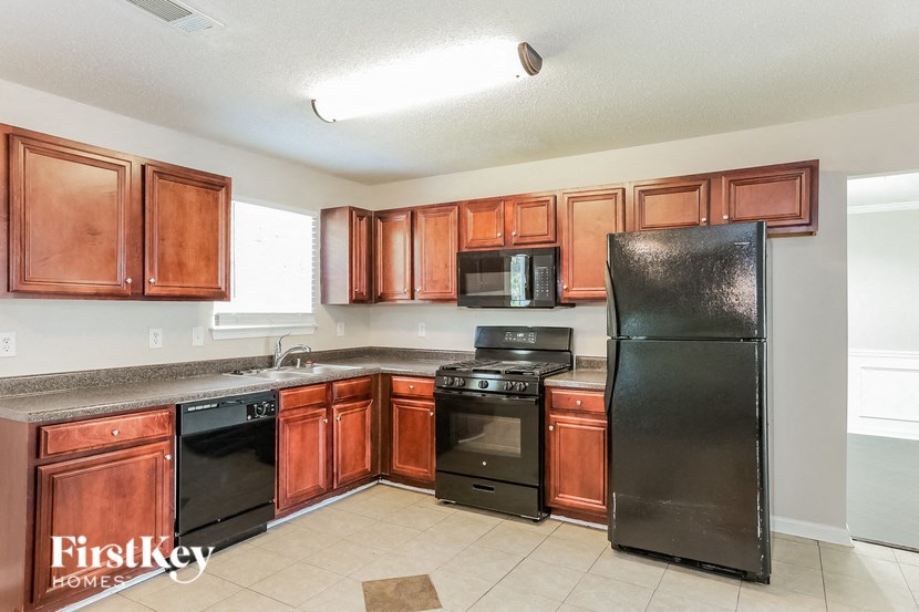 a kitchen with black appliances and wooden cabinets