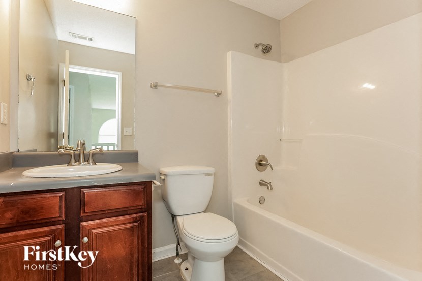 a bathroom with a sink toilet and a bath tub