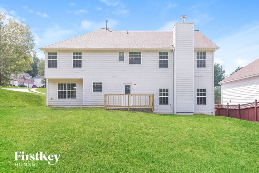 a white house with a yard in front of it