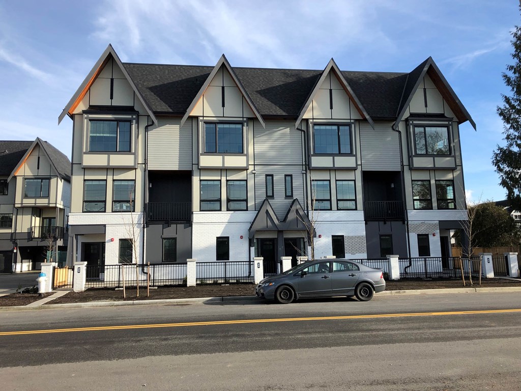a car parked in front of an apartment building