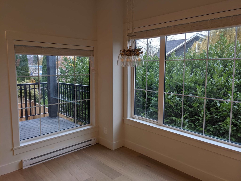 a living room with large windows and a balcony