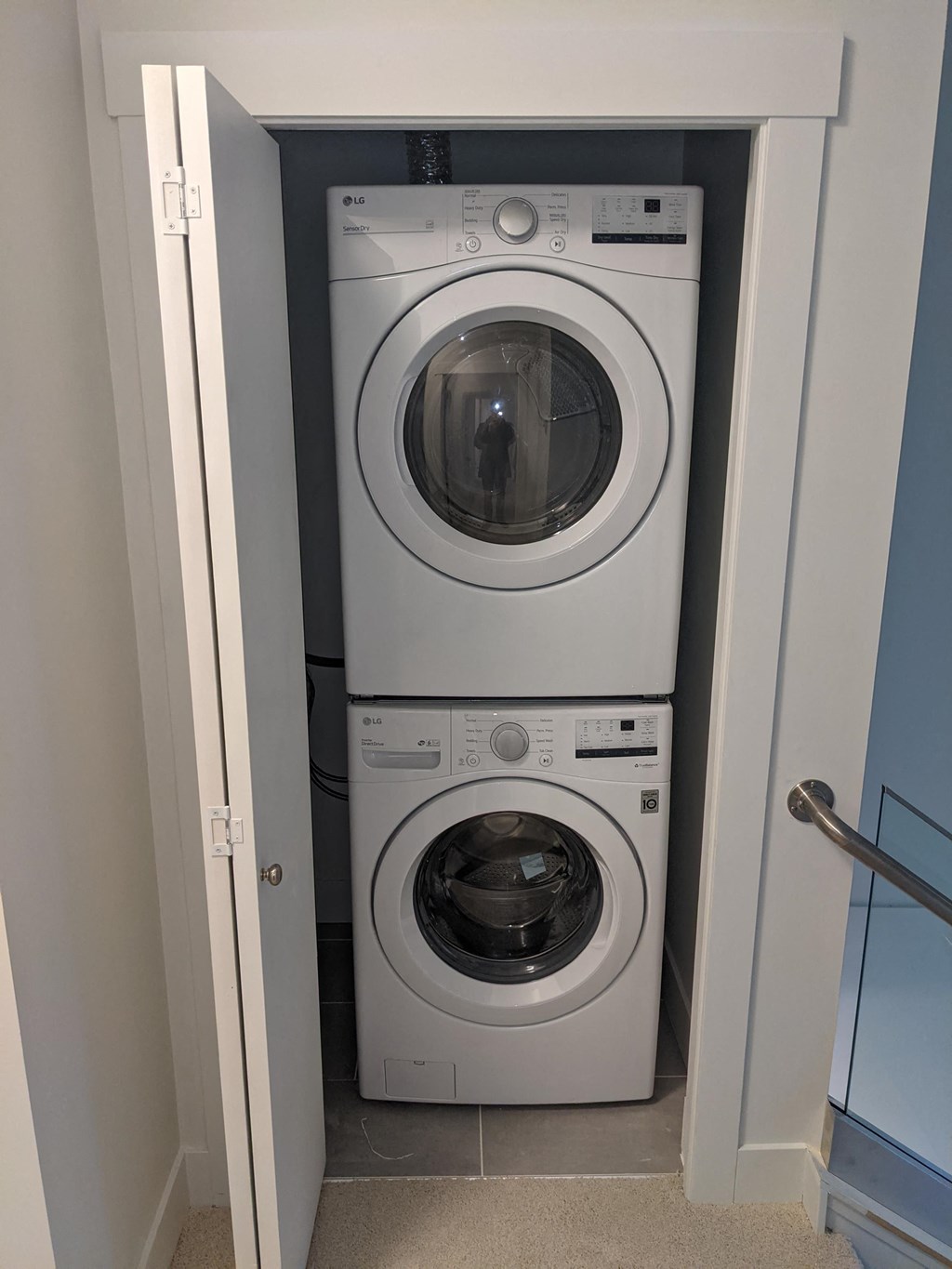 a front loading washer and dryer in a laundry room