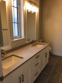 a bathroom with two sinks and a mirror