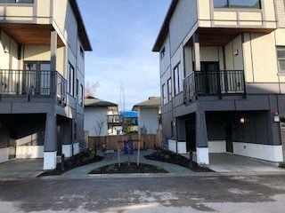 an empty parking lot between two apartment buildings