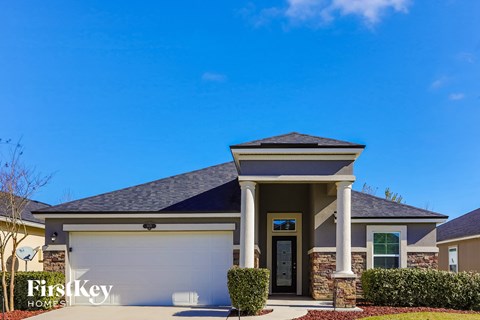 a house with a garage and a blue sky